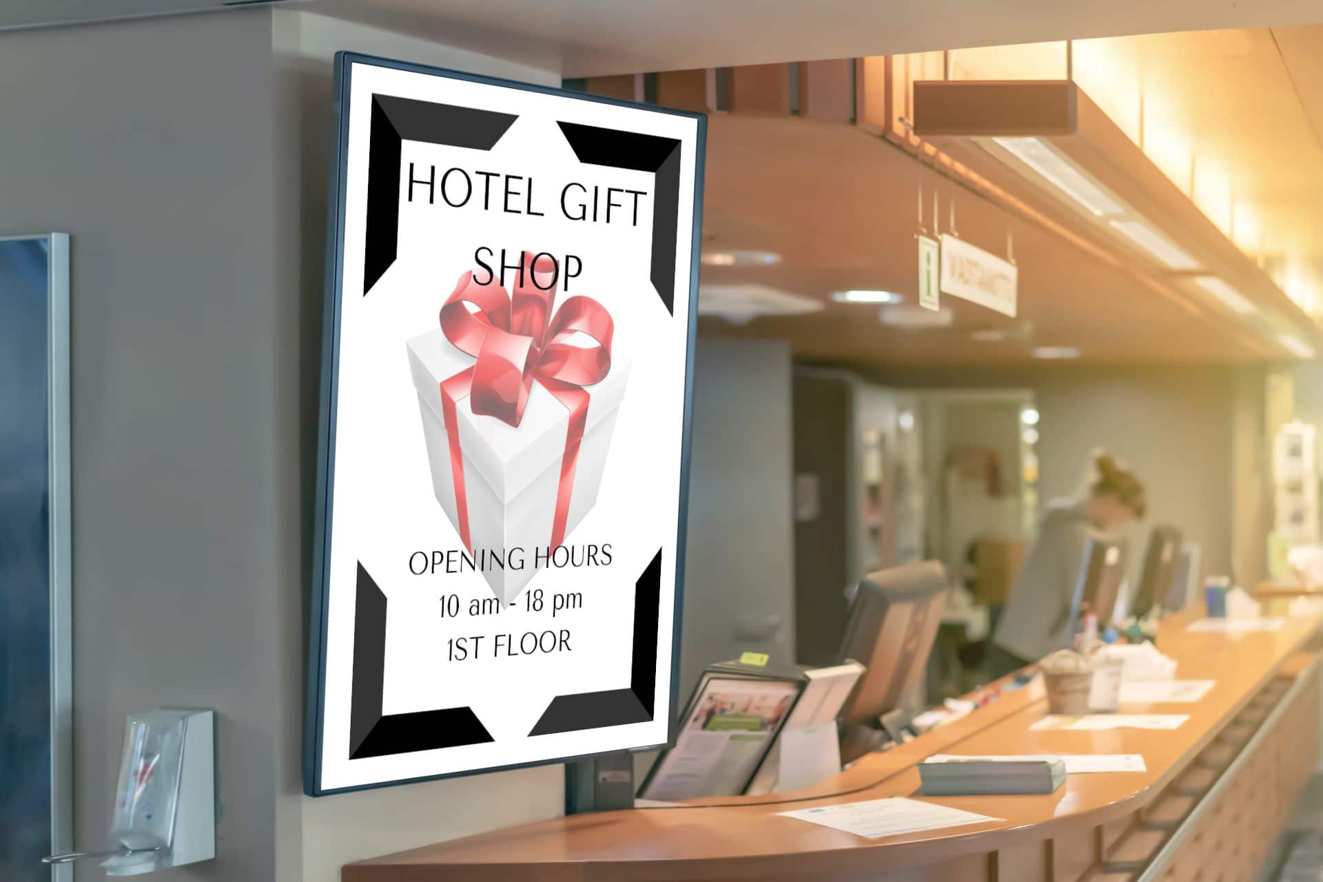 Digital signage display in front of hotel reception with information about hotel gift shop