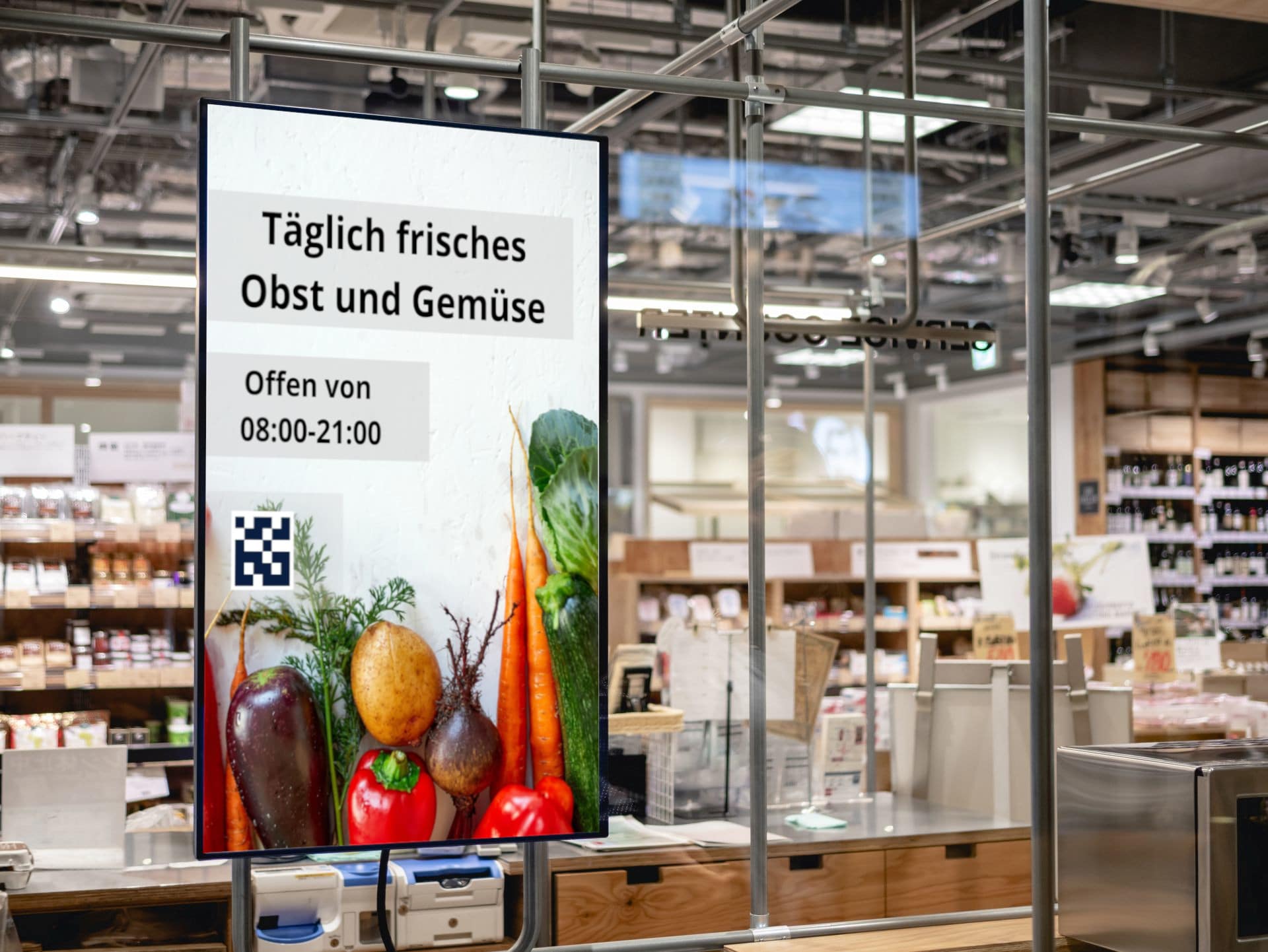 Digital signage in front of a retail store with information about open hours and QR code