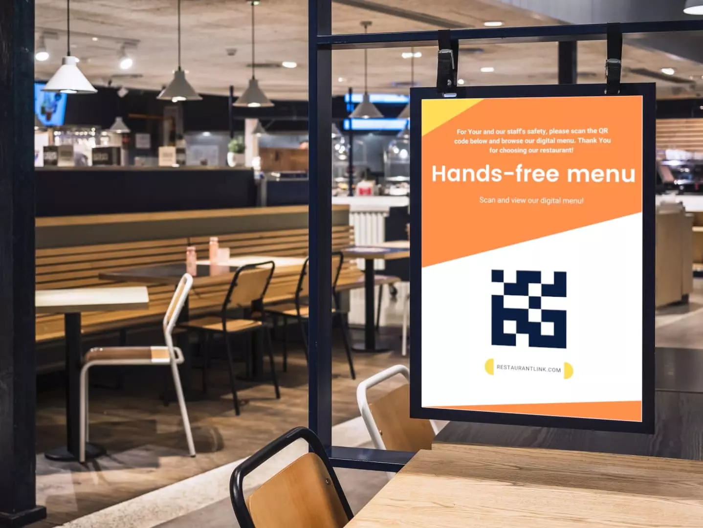 Digital signage display in a restaurant with QR code for hands-free menu download